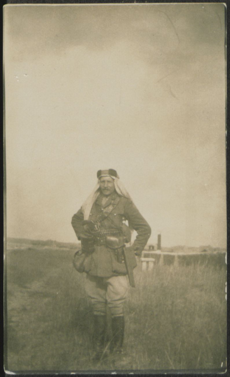 Photograph of Lt Aubrey Lees wearing military uniform and keffiyeh
